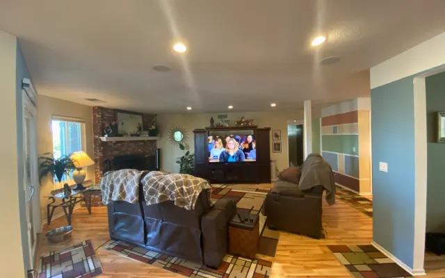 Family room with leather sofas and a brick fireplace