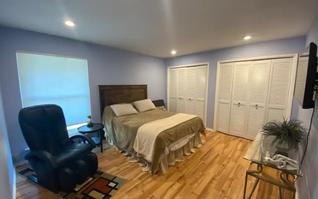 Guest bedroom with a king bed and lavender walls