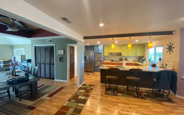 Open kitchen with pendant lights and a breakfast bar