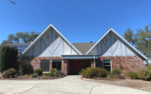 Tudor-style brick home seen from the front drive